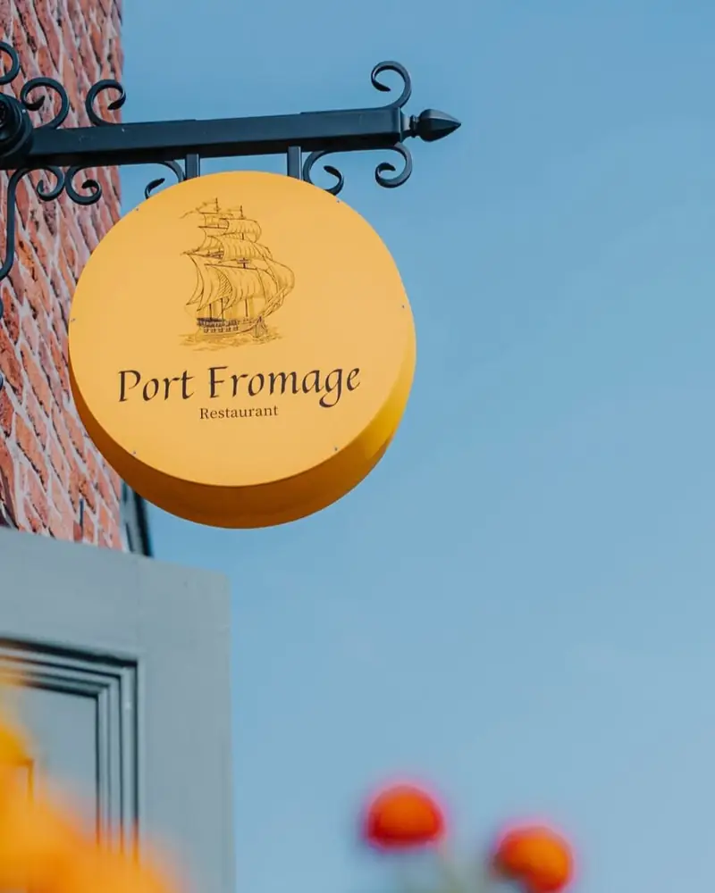 Złoty szyld Port Fromage ze statkiem
